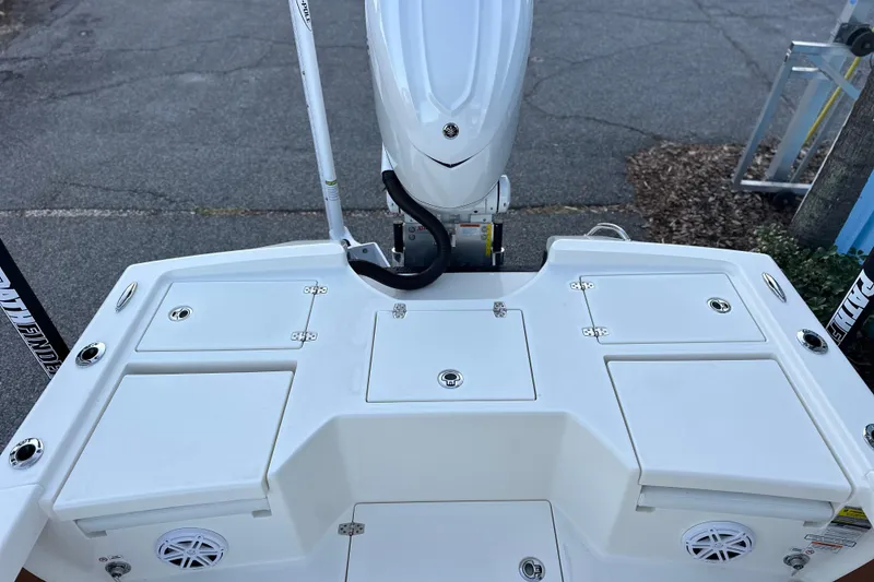 Slide: The Image of 2026 Pathfinder 2500 Hybrid boat deck with storage compartments and motor. - 7