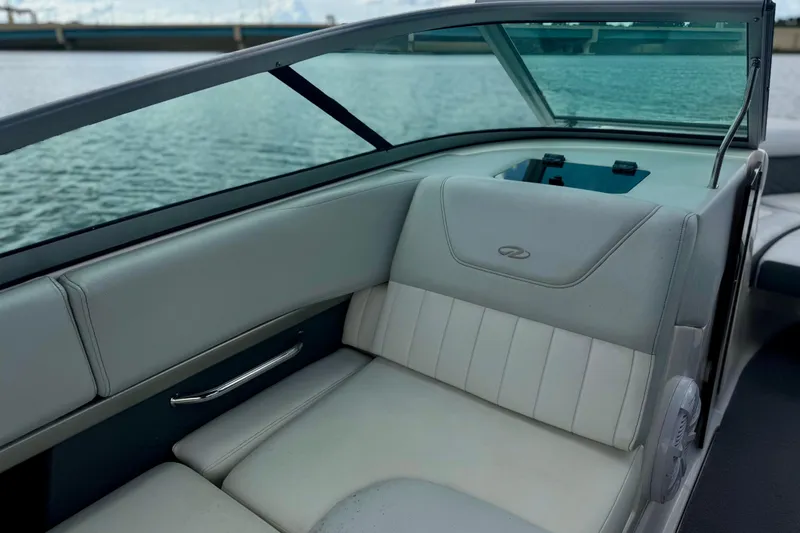Slide: The Image of Interior of a 2013 Regal 21 OBX boat with gray seating and water view. - 13