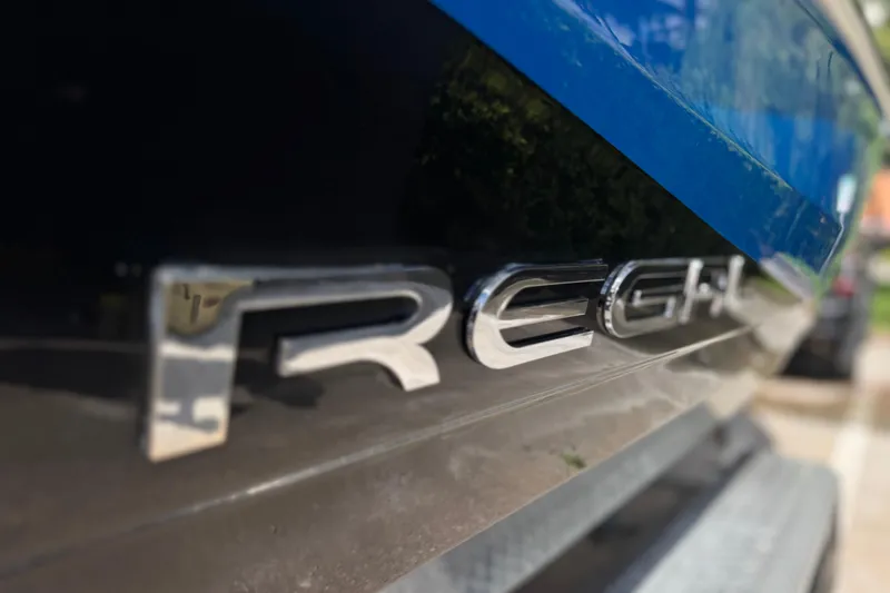 Slide: The Image of Close-up of 2013 Regal 21 OBX boat logo with blue and black detailing. - 3
