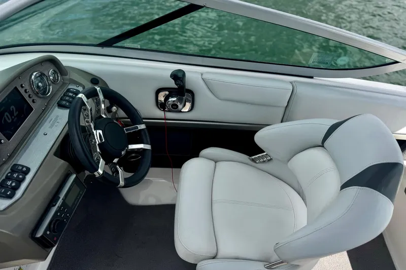 Slide: The Image of Interior of 2013 Regal 21 OBX boat with steering wheel and white seating. - 5