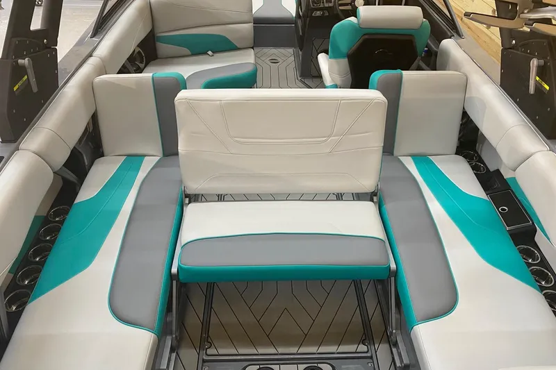 Slide: The Image of 2019 Malibu Wakesetter 24 MXZ interior with teal and gray seating. - 4