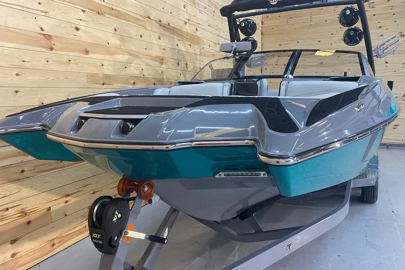 Slide: The Image of 2019 Malibu Wakesetter 24 MXZ boat in showroom, featuring sleek design and vibrant colors. - 7