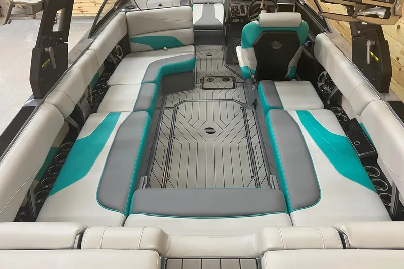 Slide: The Image of 2019 Malibu Wakesetter 24 MXZ interior with teal and gray seating, modern design. - 8