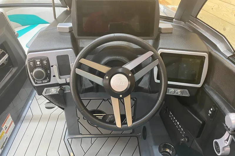 Slide: The Image of 2019 Malibu Wakesetter 24 MXZ dashboard with steering wheel and digital displays. - 9