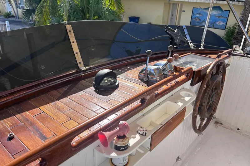 Slide: The Image of 1977 Marine Trader 40 Double Cabin helm with wooden wheel and navigation instruments. - 12