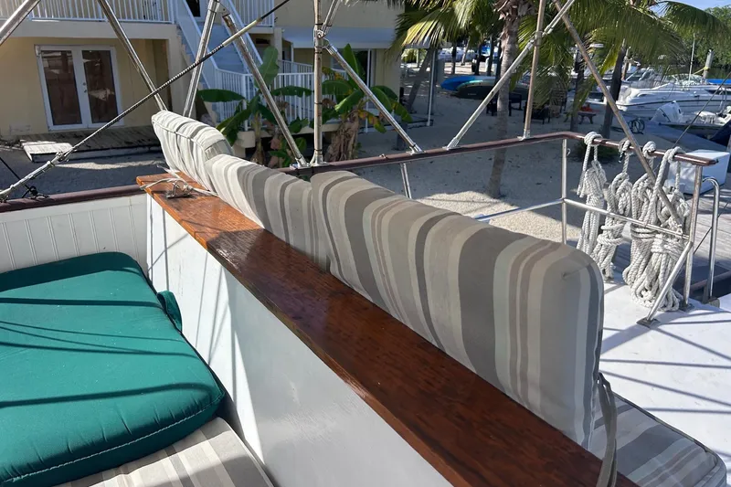 Slide: The Image of 1977 Marine Trader 40 Double Cabin deck with striped cushions and green seating. - 13