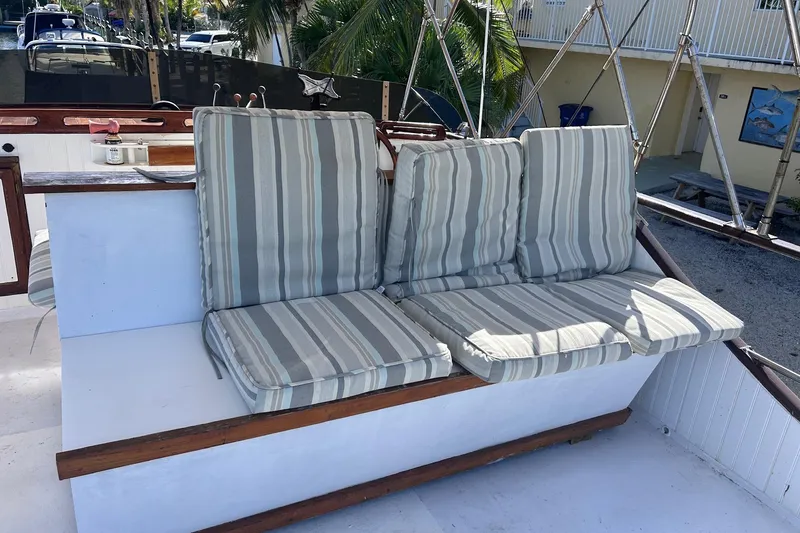 Slide: The Image of 1977 Marine Trader 40 Double Cabin with striped cushions on deck seating area. - 14
