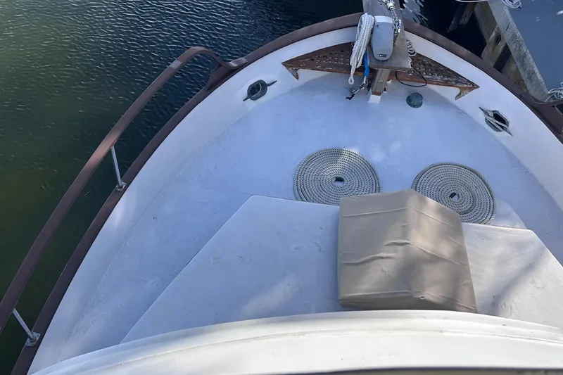 Slide: The Image of 1977 Marine Trader 40 Double Cabin boat deck with ropes and dock view. - 15