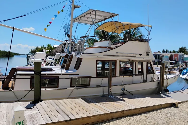 Slide: The Image of 1977 Marine Trader 40 Double Cabin yacht docked under clear blue sky. - 2