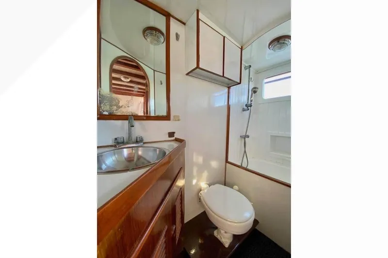 Slide: The Image of 1977 Marine Trader 40 Double Cabin bathroom with sink, toilet, and shower. - 21