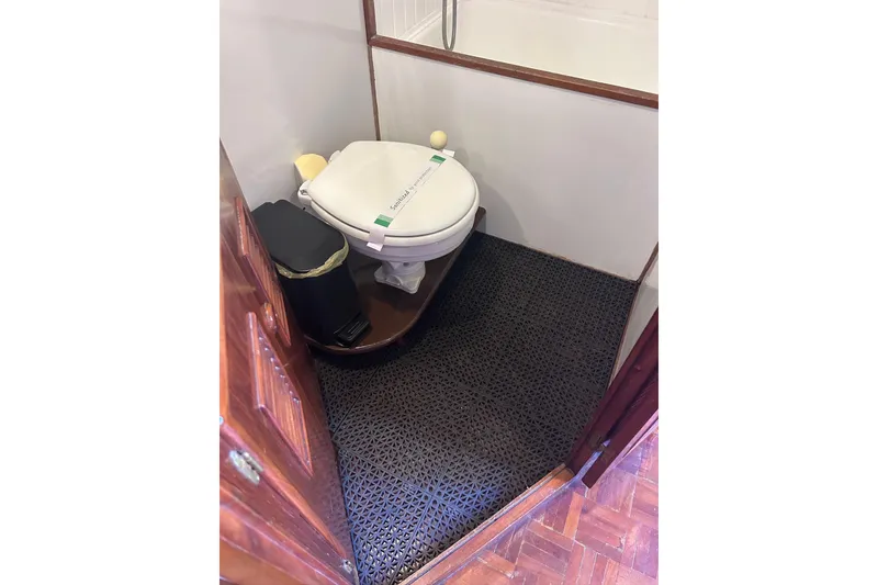 Slide: The Image of 1977 Marine Trader 40 Double Cabin bathroom with toilet and waste bin. - 23