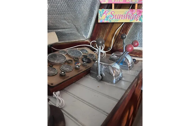 Slide: The Image of 1977 Marine Trader 40 Double Cabin helm with gauges and throttle controls. - 25