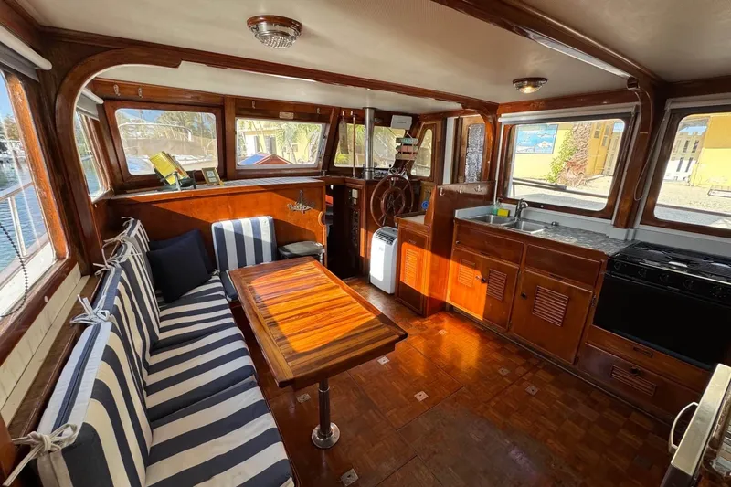 Slide: The Image of Interior of 1977 Marine Trader 40 Double Cabin with striped seating and wooden finishes. - 28