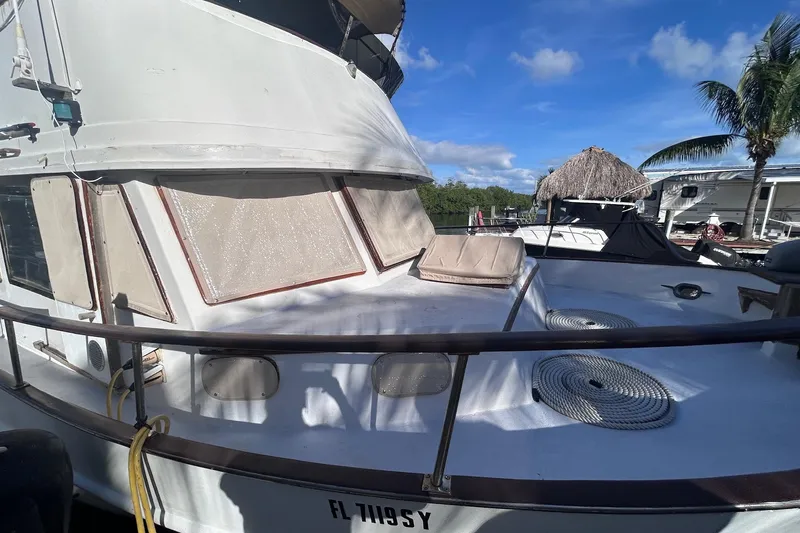 Slide: The Image of 1977 Marine Trader 40 Double Cabin boat docked under clear blue sky. - 3