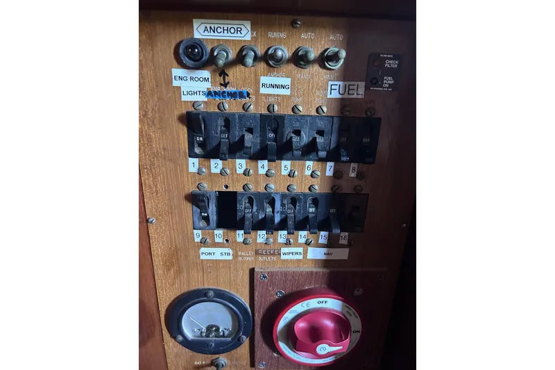 Slide: The Image of 1977 Marine Trader 40 Double Cabin electrical panel with switches and controls. - 36