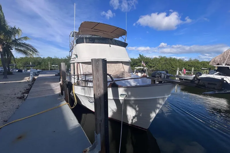 Slide: The Image of 1977 Marine Trader 40 Double Cabin docked under blue sky. - 37