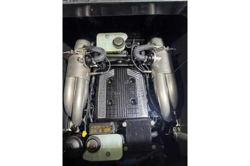 Slide: The Image of 2022 Malibu M240 engine compartment with supercharged components and dual exhaust pipes. - 13