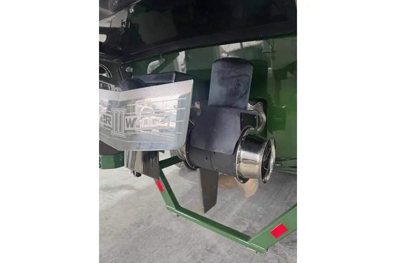 Slide: The Image of 2022 Malibu M240 boat rear view with propeller and exhaust system. - 14