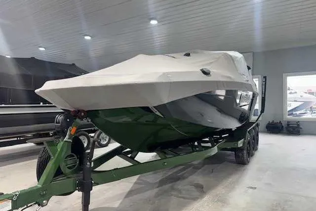 Slide: The Image of 2022 Malibu M240 boat on trailer, covered, in indoor storage facility. - 16