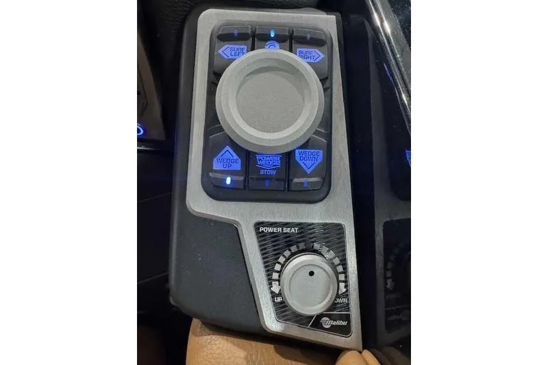 Slide: The Image of Control panel of a 2022 Malibu M240 boat with illuminated buttons and power seat adjustment. - 3