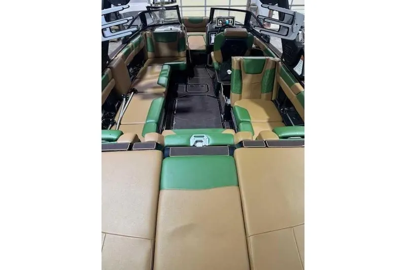 Slide: The Image of 2022 Malibu M240 boat interior with green and tan seating, modern design. - 4