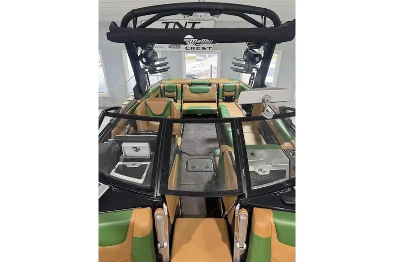 Slide: The Image of 2022 Malibu M240 boat interior with green and tan seating, sleek design, and modern features. - 5
