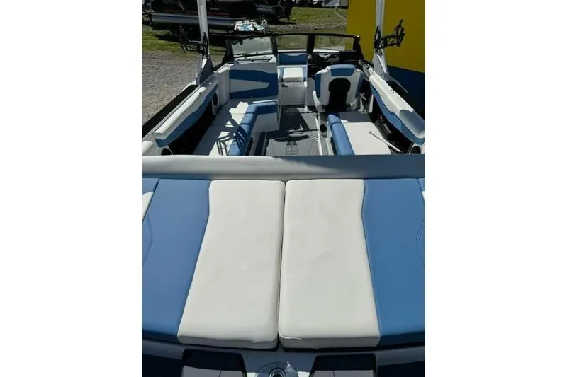 Slide: The Image of 2024 Axis T235 boat interior with blue and white seating, showcasing spacious design. - 4