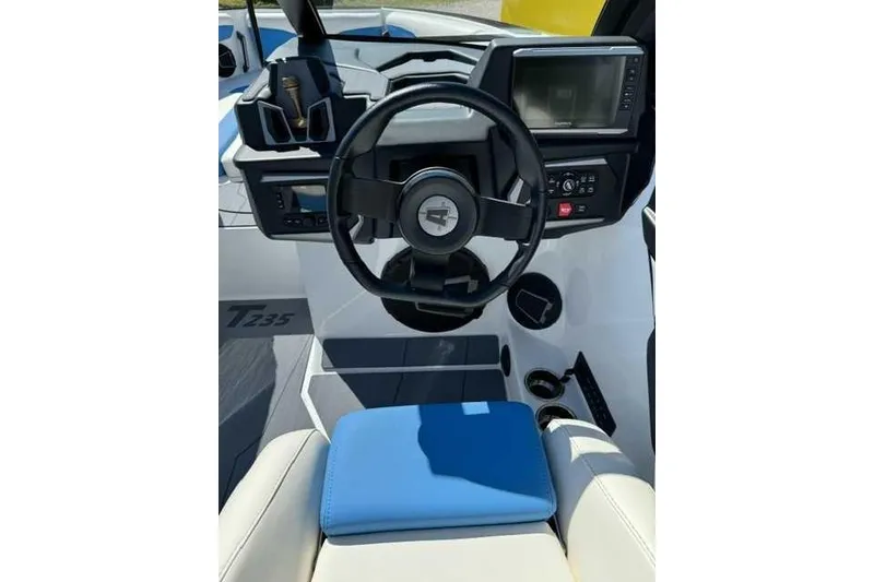 Slide: The Image of 2024 Axis T235 boat dashboard with steering wheel and modern controls. - 6