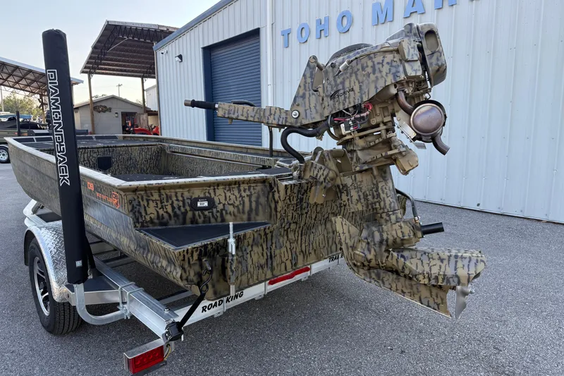 Slide: The Image of 2025 Diamondback Mud Rattler 1860 boat with camouflage design on a trailer. - 10