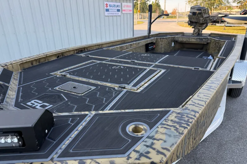 Slide: The Image of 2025 Diamondback Mud Rattler 1860 boat with camouflage design and spacious deck. - 4