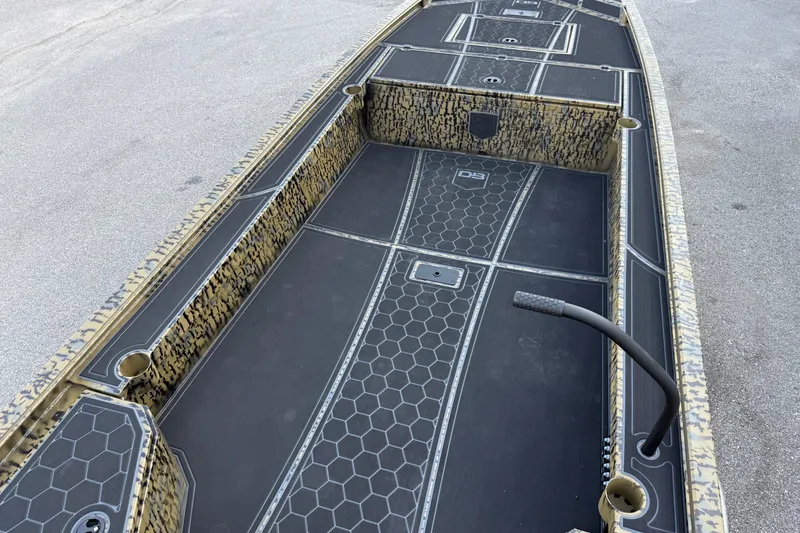 Slide: The Image of 2025 Diamondback Mud Rattler 1860 boat interior with hexagonal pattern flooring. - 7