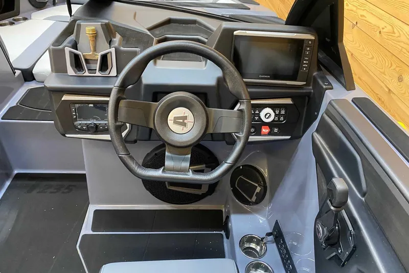 Slide: The Image of 2024 Axis T235 boat dashboard with steering wheel, control panel, and navigation screen. - 5