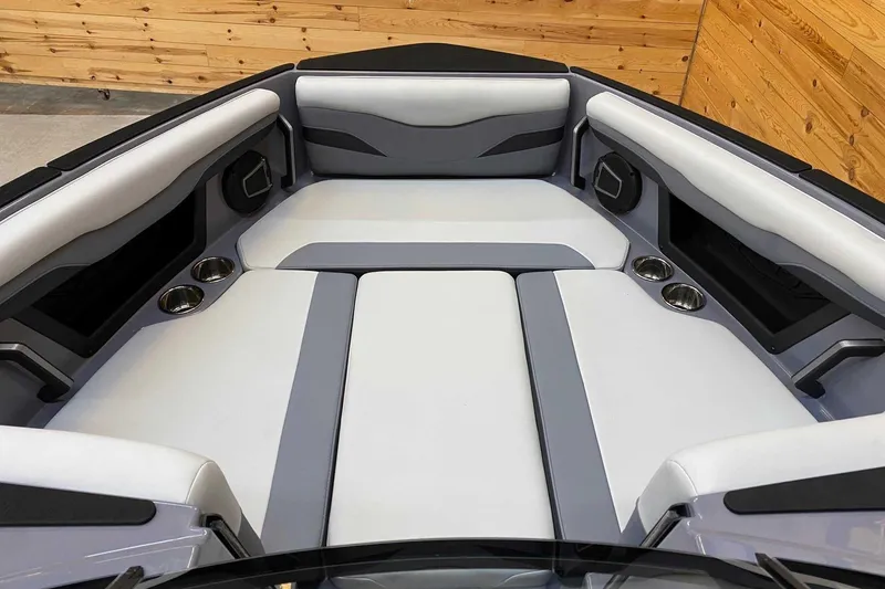 Slide: The Image of 2024 Axis T235 boat interior with cushioned seating and cup holders. - 6