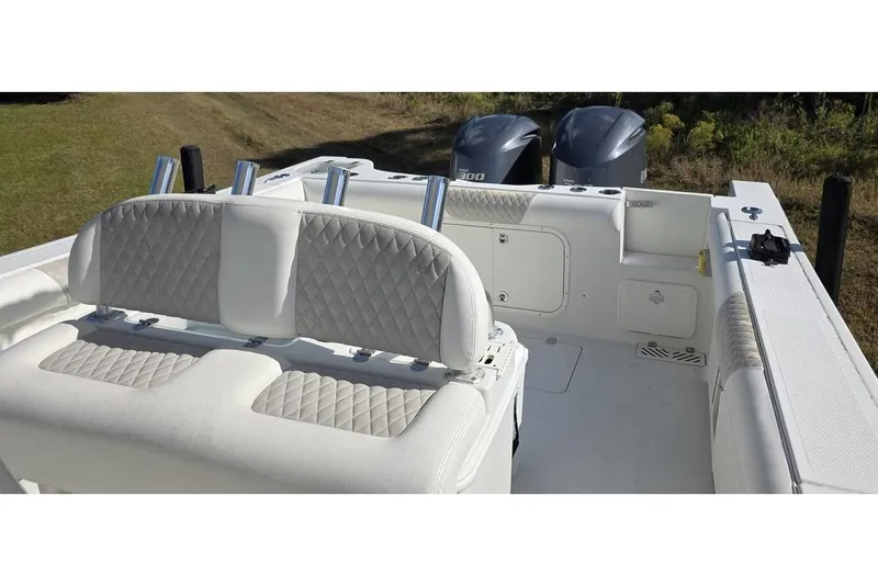 Slide: The Image of 2013 Sailfish 320 CC boat interior with dual engines and cushioned seating. - 16