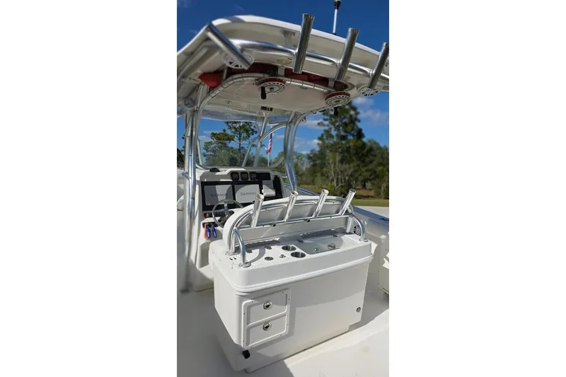 Slide: The Image of 2013 Sailfish 320 CC boat console with rod holders and navigation equipment. - 21
