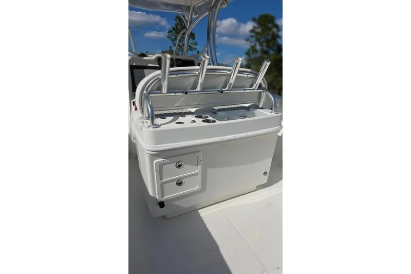 Slide: The Image of 2013 Sailfish 320 CC boat console with rod holders and storage drawers. - 22