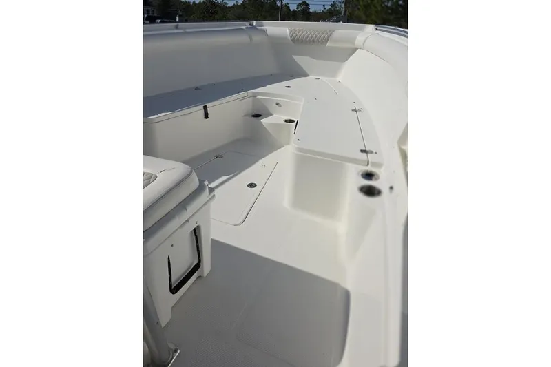 Slide: The Image of 2013 Sailfish 320 CC boat interior, featuring spacious seating and storage compartments. - 26