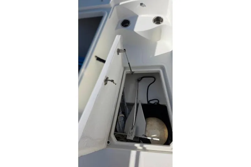 Slide: The Image of Open storage compartment on 2013 Sailfish 320 CC boat, showing anchor and equipment. - 34