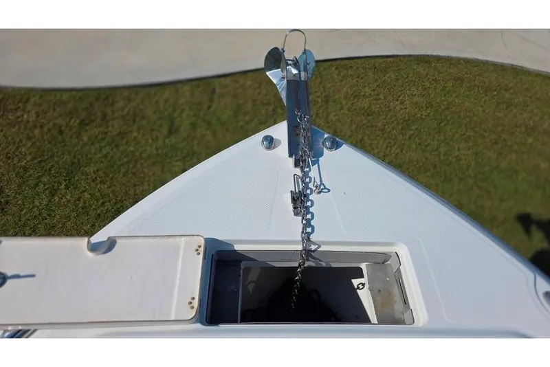 Slide: The Image of Bow view of 2013 Sailfish 320 CC boat with anchor chain and storage compartment. - 36