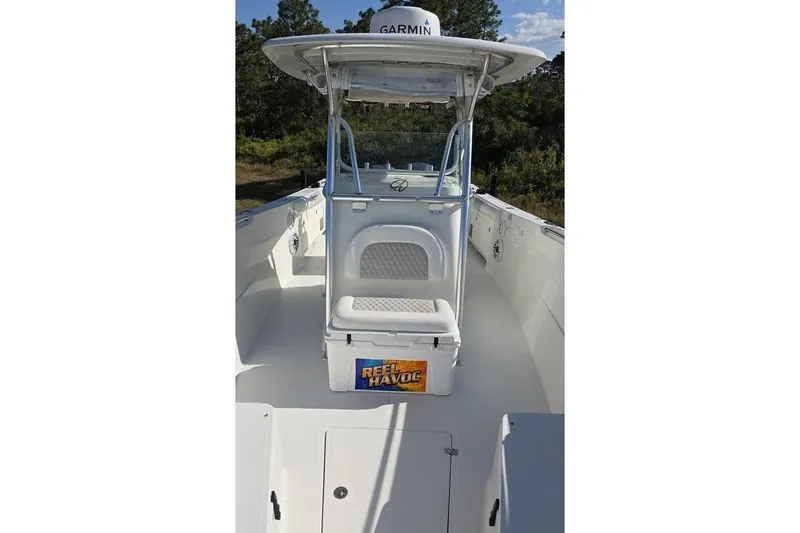Slide: The Image of 2013 Sailfish 320 CC boat interior with Garmin equipment and seating. - 38