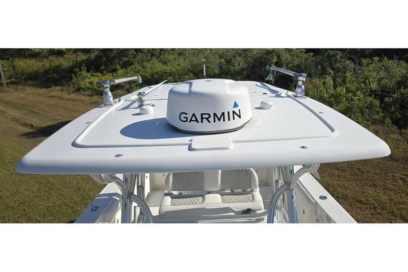 Slide: The Image of 2013 Sailfish 320 CC boat with Garmin radar on the roof, surrounded by greenery. - 39