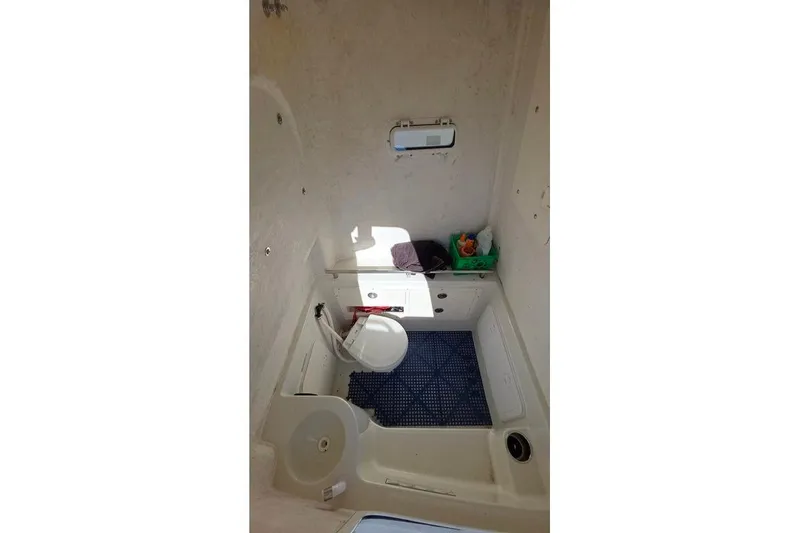 Slide: The Image of 2013 Sailfish 320 CC cabin interior with storage and seating area. - 45