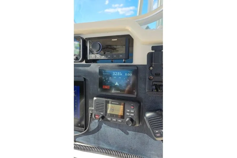 Slide: The Image of Dashboard of a 2013 Sailfish 320 CC boat with Garmin and Fusion electronics. - 52
