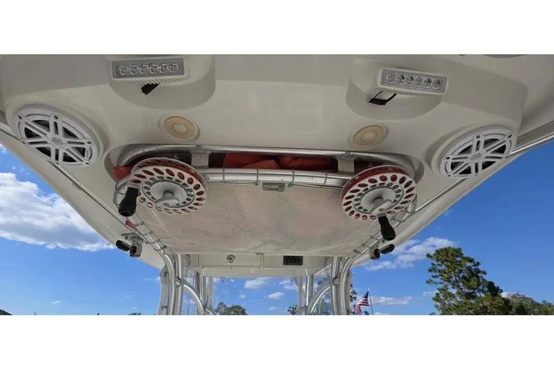 Slide: The Image of 2013 Sailfish 320 CC boat roof with speakers and fishing rod holders. - 55