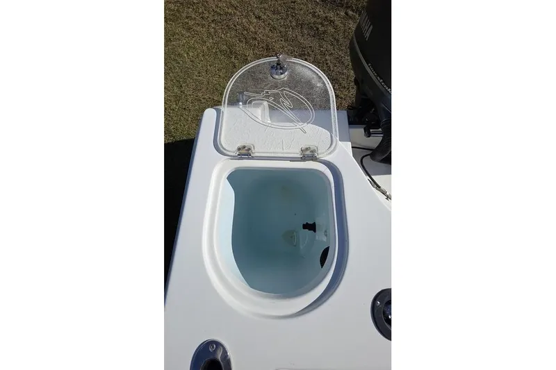 Slide: The Image of Open livewell on 2013 Sailfish 320 CC boat, showcasing interior design. - 59