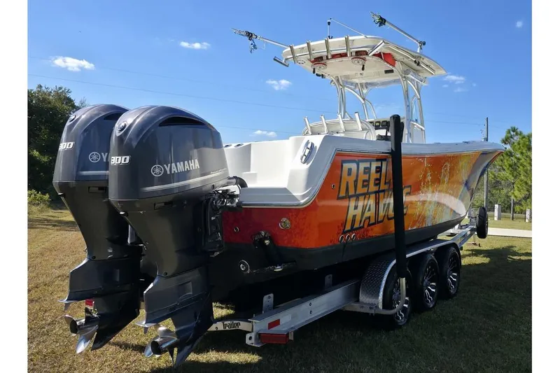 Slide: The Image of 2013 Sailfish 320 CC boat with dual Yamaha 300 engines on a trailer. - 6