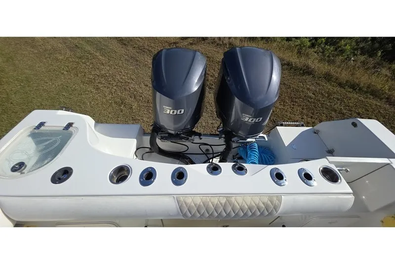 Slide: The Image of 2013 Sailfish 320 CC boat with dual Yamaha 300 engines, rear view. - 61