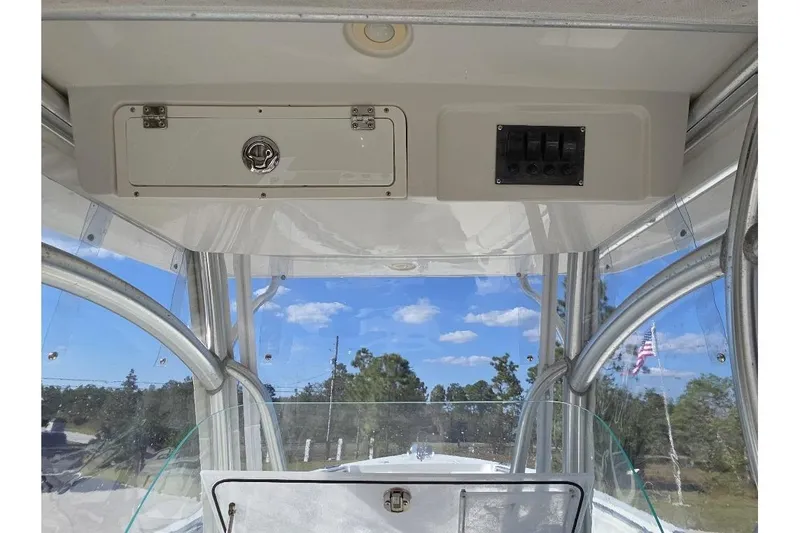 Slide: The Image of 2013 Sailfish 320 CC boat interior with control panel and clear sky view. - 64