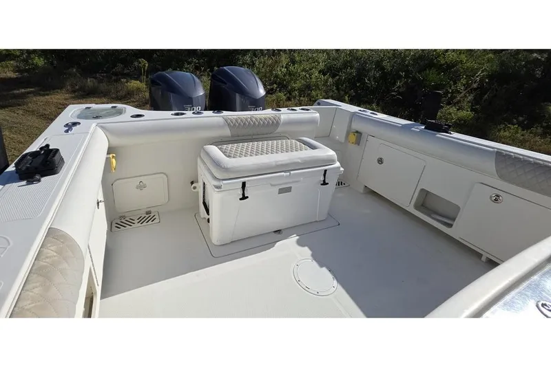 Slide: The Image of 2013 Sailfish 320 CC boat interior with seating and storage compartments. - 66