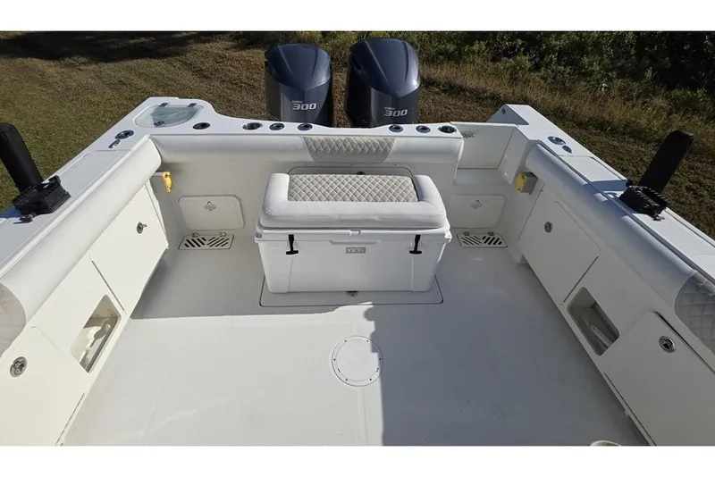 Slide: The Image of 2013 Sailfish 320 CC boat deck with seating and storage compartments. - 67